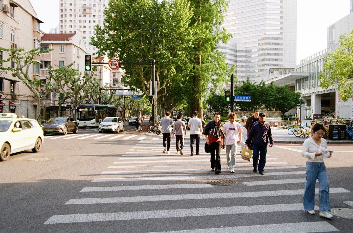 Pedestrians crossing a busy street in Shanghai, China